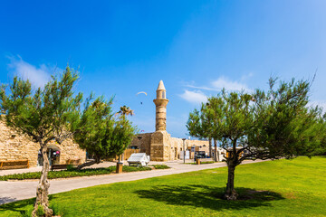 The minaret is surrounded by grass lawn