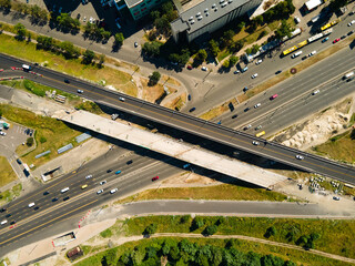 UKRAINE, KYIV - JULE 09, 2020: Aerial shot of highway reconstruction on Stepan Bandera Avenue in Kyiv. Bridge construction near the Pochayna metro station  - 364077699