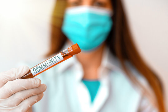 Conceptual hand writing showing Community. Concept meaning group of showing with a common characteristics living together Laboratory blood test sample for medical diagnostic analysis