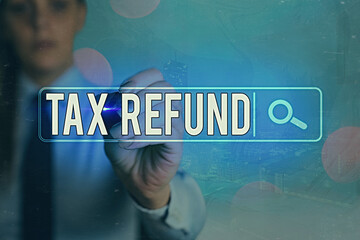 Writing note showing Tax Refund. Business concept for excess payment of paid taxes returned to...