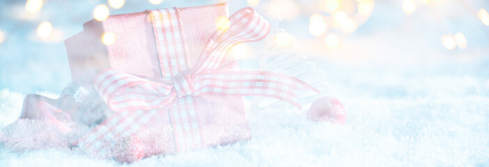 Christmas gift box with bokeh lights in the snow - Christmas greeting card with copy space