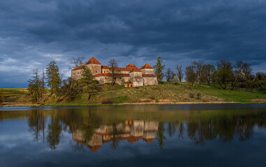 Fototapeta na wymiar Ancient Svirzh castle at sunset in april 2020. Svirzh village, Lviv region.