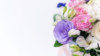 beautiful bouquet of multi-colored eustomas close-up, copy space. Focus on the petals, white background blurred
