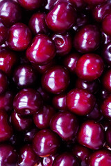 Appetizing shiny ripe sweet cherry. Large maroon berries - food vertical background