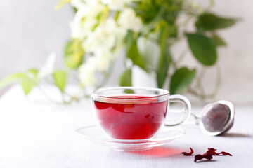 Healthy hibiscus tea in transparent cup