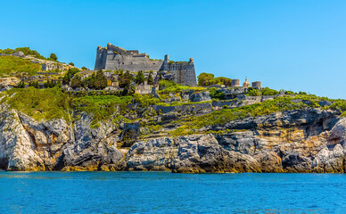 Fototapeta na wymiar A view looking back towards the castle in Porto Venere, Italy in the summertime