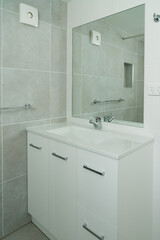 New ensuite bathroom with vanity unit, basin and tiled walls and floor