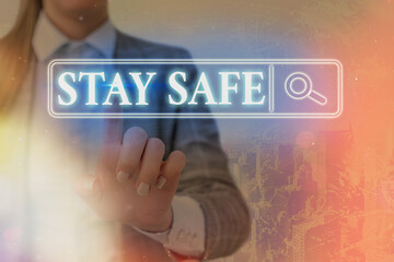Writing note showing Stay Safe. Business concept for secure from threat of danger, harm or place to...