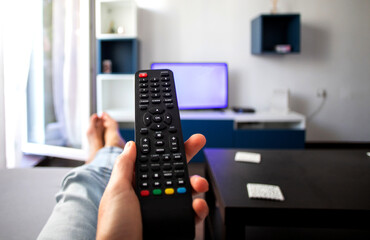 watching tv at home focus on remote control