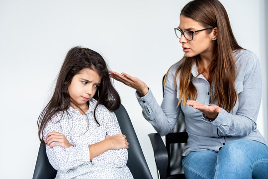 Young Strict Mother Or Sister Scolding Stubborn Kid Girl.