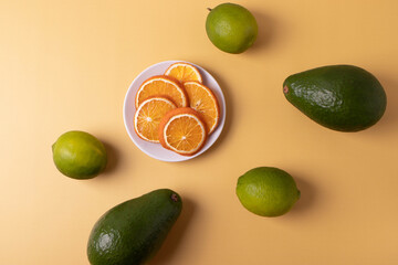green citrus limes and other fruits on yellow
