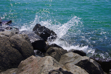 Waves breaking on large stones on the coast.
