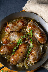 Homemade white sausage fried with onion and herbs