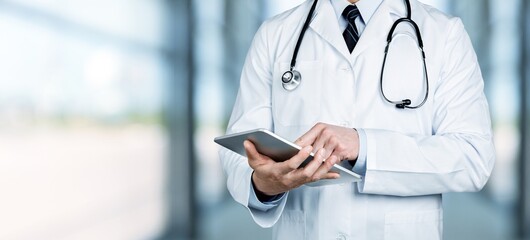 Man doctor using a digital tablet