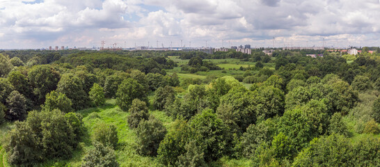 aerial panorama over Oude Landen nature park in Ekeren, with village and harbor in the distance