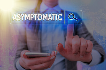 Writing note showing Asymptomatic. Business concept for a condition or an individual producing or...