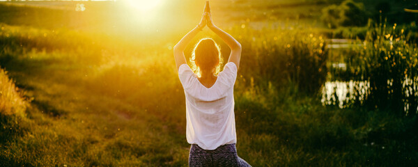 woman in a yoga pose at sunset by lakeside mindfulness and mental health