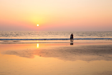 Romantic couple and idyllic sunset in  South India at the beach
