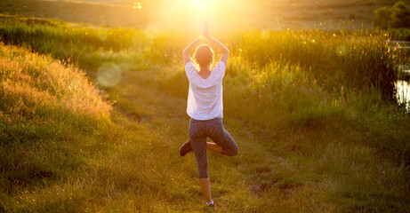 woman in a yoga pose at sunset by lakeside mindfulness and mental health