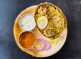 raditionally made delicious hot Chicken Biryani served in donne (banana plant basket) in India