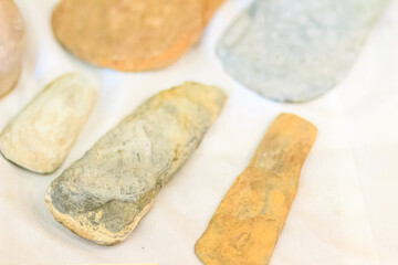 Ancient stone and metal axes, a human tool around 4,000 years of prehistoric period. Hand axe is a prehistoric stone tool with two faces that is tool in human history usually made from flint or chert.