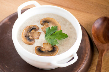 Mushroom soup puree. Serving dishes. Soup in a white plate