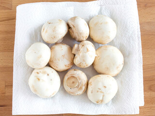 Dry mushrooms on a white kitchen towel after washing. For cooking a soup soup