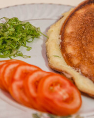 Fluffy omelette with tomatoes and greens