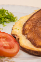 Fluffy omelette with tomatoes and greens