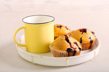 Blueberry cakes and cup of milk, served
