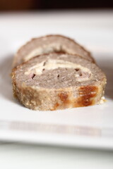 Meat roulade. Rolled meat with a filling of cheese and ham.