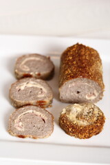 Meat roulade. Rolled meat with a filling of cheese and ham.