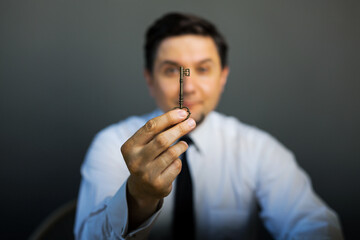 Key to success in businessman hand on background of the sky.