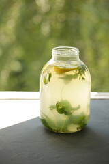 Can of lemonade on the window. Mojito.
