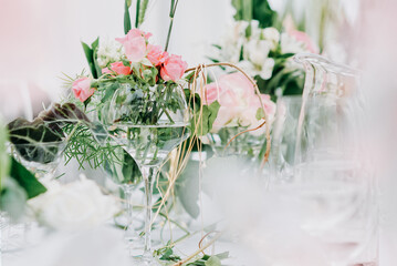 The wedding decor. Table set for an event party or wedding reception. Beautiful flowers on table.
