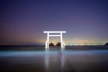floating torii in ocean and starry