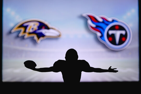 Baltimore Ravens Vs. Tennessee Titans . NFL Game. American Football League Match. Silhouette Of Professional Player Celebrate Touch Down. Screen In Background.