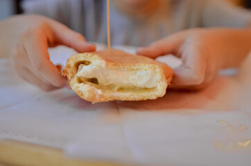 Donut with cream filling. Man eating waffles with ice cream.