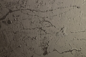 Slate serving board with water drops, close-up.