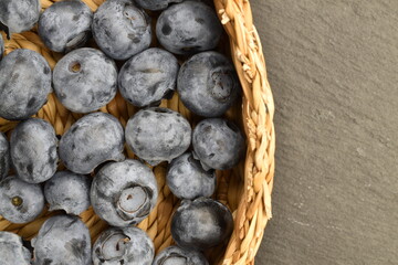 Ripe juicy organic blueberries, close-up, on a slate board.