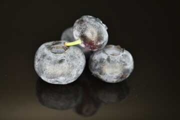 Ripe juicy organic blueberries, close-up, isolated on black.