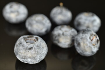 Ripe juicy organic blueberries, close-up, isolated on black.