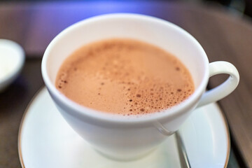 A cup of hot chocolate with lots of foamy bubbles