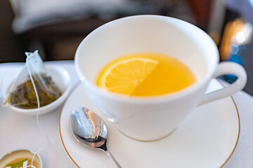 A cup of hot green tea with slice of lemon