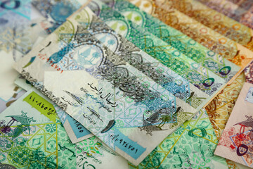  Currencies and money exchange trading concepts. Qatari 500 ,100,50,10,5,1 Riyals Bank Note .& Coins ,Qatari Currency roll