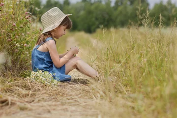 Poster Cute girl in the blue dress on the rural field © Albert Ziganshin