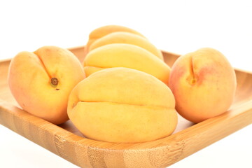 Ripe organic yellow apricot, close-up, isolated on white.