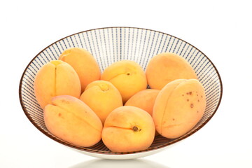 Ripe organic yellow apricot, close-up, isolated on white.