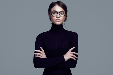 Cute student girl wearing black turtleneck sweater and stylish eyeglasses - obrazy, fototapety, plakaty