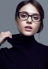 Fototapeta na wymiar Cute student girl wearing black turtleneck sweater and stylish eyeglasses